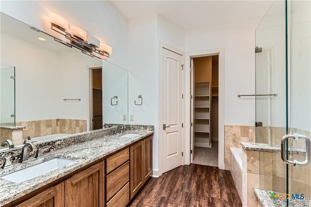 462 Stagecoach Trl, San Marcos, TX 78666 - full bathroom with a bath, a shower stall, double vanity, and wood finished floors
