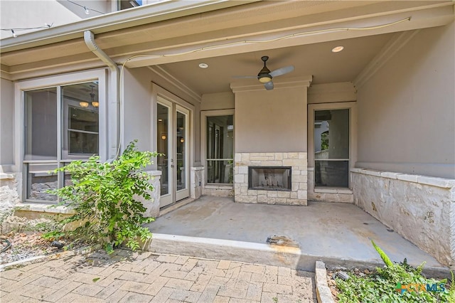 462 Stagecoach Trl, San Marcos, TX 78666 - view of patio with exterior fireplace, a ceiling fan, and french doors