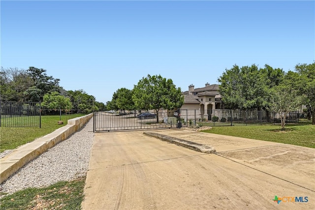 462 Stagecoach Trl, San Marcos, TX 78666 - view of concrete driveway with a gate and a gated entry