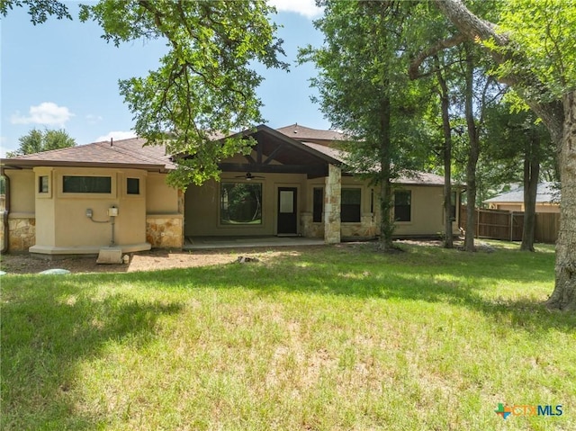 1010 Woodland Bend Cir, Salado, TX 76571 - back of house featuring a ceiling fan, stone siding, and stucco siding