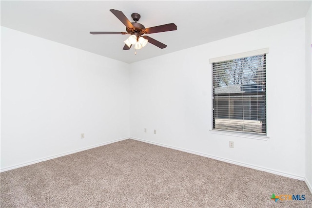 spare room with baseboards, a ceiling fan, and carpet flooring