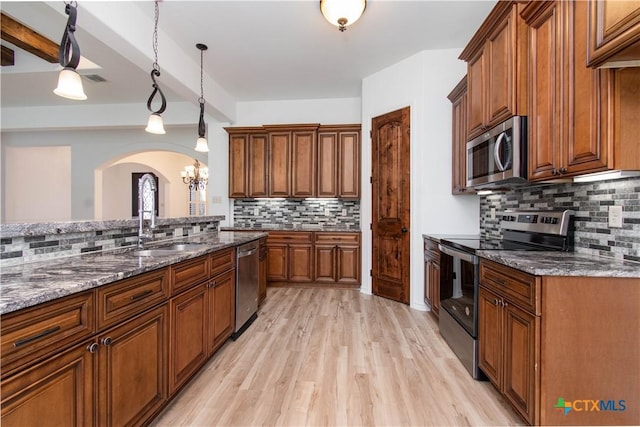 kitchen featuring brown cabinets and stainless steel appliances