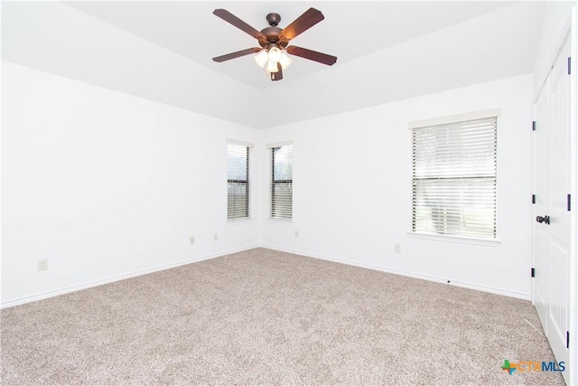 unfurnished room with carpet flooring, baseboards, and a wealth of natural light