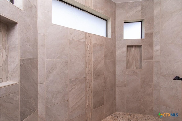 bathroom featuring tiled shower