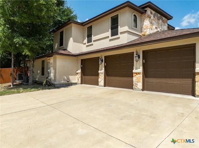 1010 Woodland Bend Cir, Salado, TX 76571 - view of front of property with stone siding, stucco siding, an attached garage, and driveway