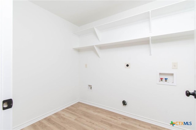 clothes washing area featuring light wood-style flooring, baseboards, hookup for an electric dryer, hookup for a washing machine, and laundry area