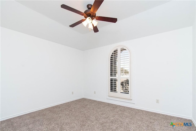 spare room with baseboards, a ceiling fan, and carpet flooring