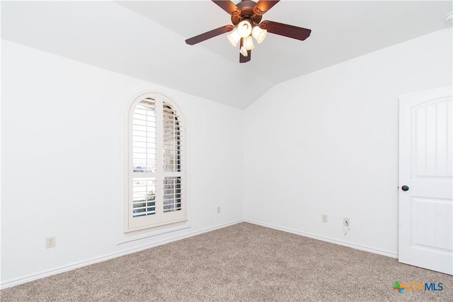 empty room featuring ceiling fan, baseboards, carpet, and lofted ceiling