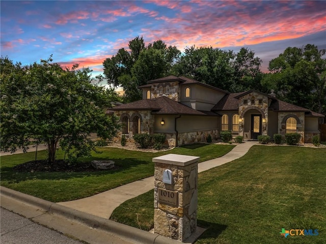1010 Woodland Bend Cir, Salado, TX 76571 - mediterranean / spanish-style house featuring stone siding, a lawn, and stucco siding