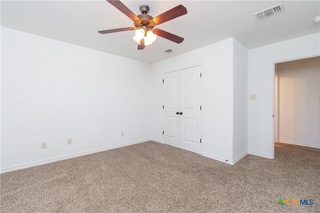 unfurnished bedroom featuring a closet, visible vents, baseboards, and carpet