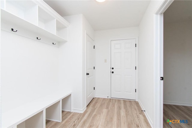 mudroom featuring light wood-style floors and baseboards