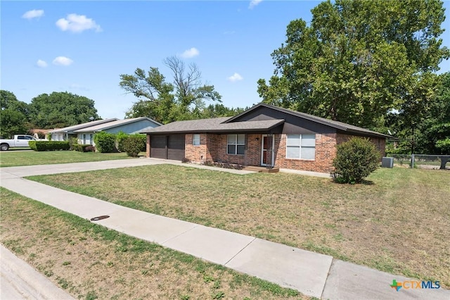 ranch-style house featuring a front lawn and central air condition unit