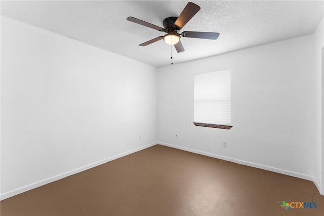 empty room featuring ceiling fan, concrete flooring, and a textured ceiling