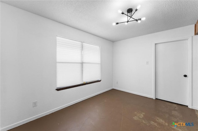 unfurnished bedroom with an inviting chandelier and a textured ceiling