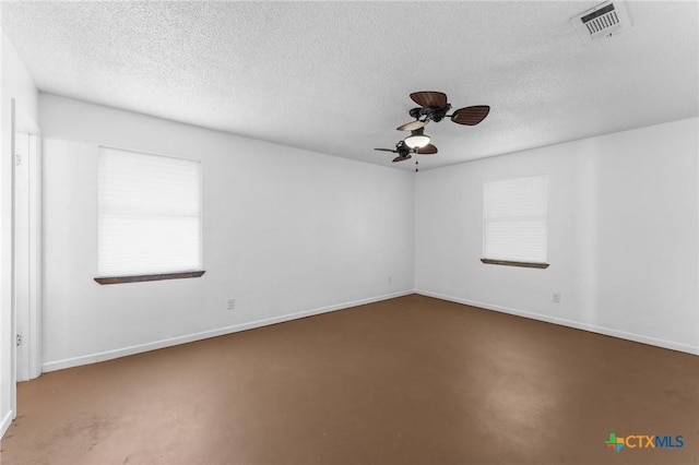 unfurnished room featuring concrete flooring, a textured ceiling, and ceiling fan