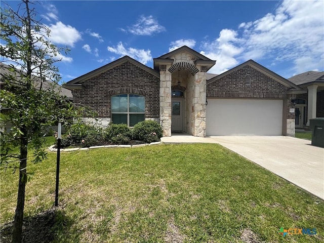 212 Bainbridge Dr, Temple, TX 76502 - view of front of property featuring a front yard, stone siding, concrete driveway, brick siding, and a garage