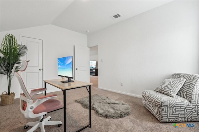 office area featuring carpet, visible vents, vaulted ceiling, and baseboards