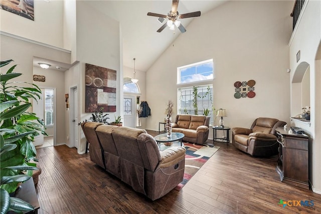 living room with ceiling fan, high vaulted ceiling, and dark wood-style flooring