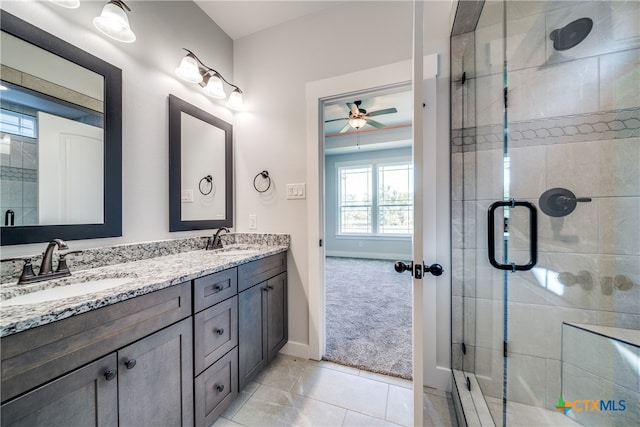 bathroom with vanity, tile patterned flooring, ceiling fan, and a shower with shower door