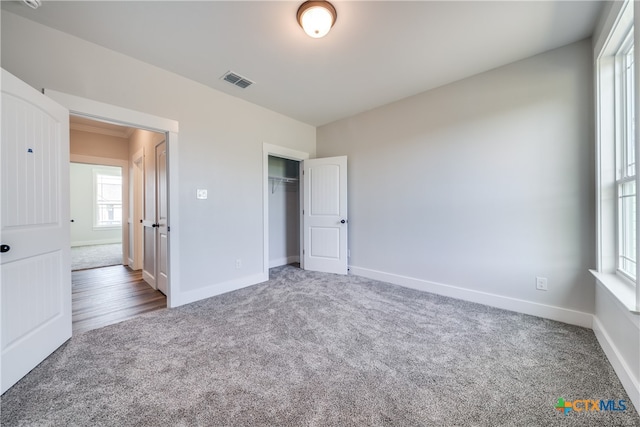 unfurnished bedroom with carpet and a closet