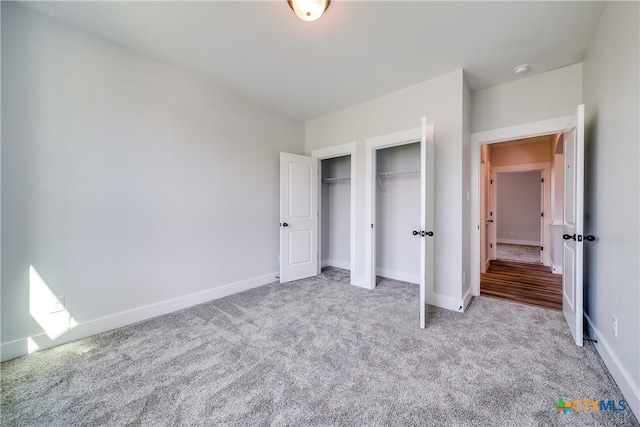 unfurnished bedroom featuring light carpet