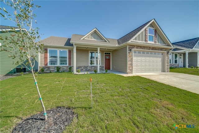 craftsman-style house with stone siding, driveway, and a front lawn