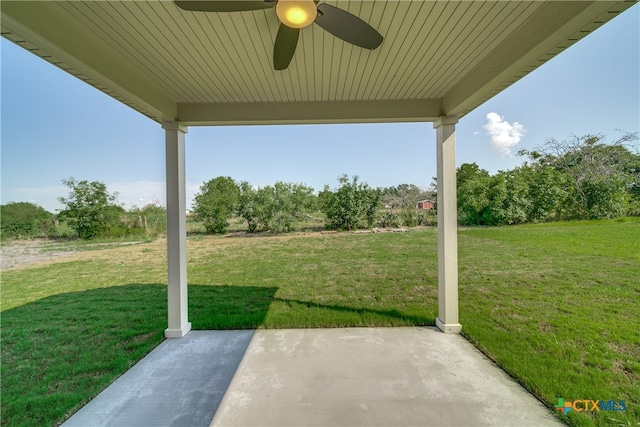 view of yard featuring ceiling fan and a patio