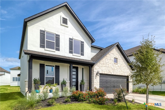 1965 Alasio Dr, Leander, TX 78641 - view of front of property featuring stucco siding, a garage, concrete driveway, and covered porch