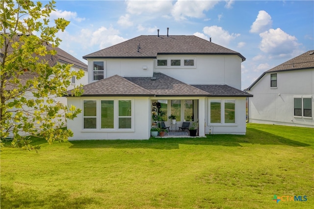 1965 Alasio Dr, Leander, TX 78641 - rear view of house featuring roof with shingles, a patio area, a lawn, and stucco siding