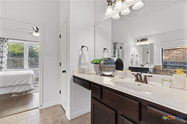 bathroom featuring baseboards, a ceiling fan, connected bathroom, vanity, and tile patterned flooring