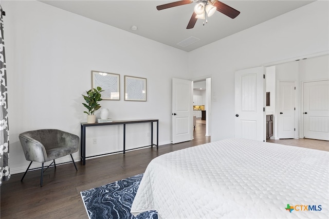 bedroom featuring visible vents, baseboards, a ceiling fan, and wood finished floors