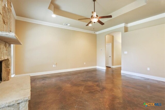 703 Cosper Creek Dr, Killeen, TX 76542 - unfurnished living room featuring a ceiling fan, arched walkways, a stone fireplace, crown molding, and finished concrete floors