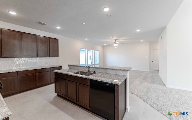 kitchen with sink, light carpet, tasteful backsplash, a kitchen island with sink, and dishwasher