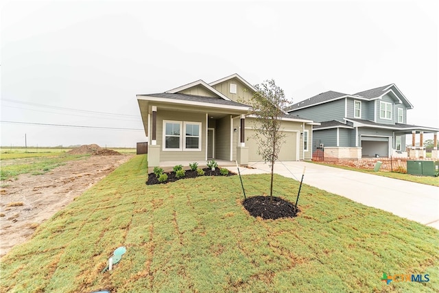 craftsman-style house featuring a front yard and a garage