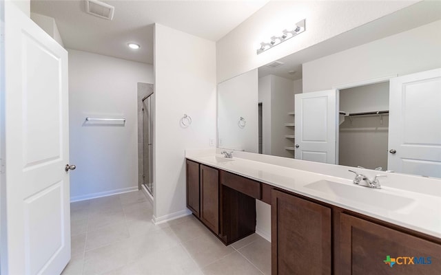 bathroom featuring vanity, tile patterned floors, and an enclosed shower