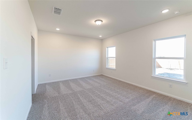 unfurnished room featuring carpet