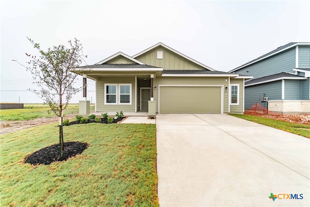 view of front of home with a front lawn and a garage