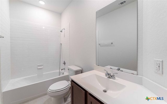 full bathroom featuring vanity, tiled shower / bath combo, and toilet