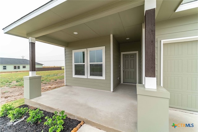 view of exterior entry featuring a garage