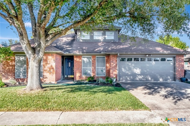 view of front of property with a front lawn and a garage