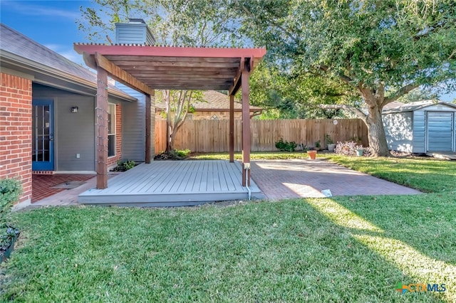 view of yard featuring a pergola, a shed, a wooden deck, and a patio area