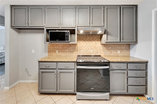 kitchen featuring gray cabinetry, backsplash, light tile patterned flooring, and stainless steel appliances