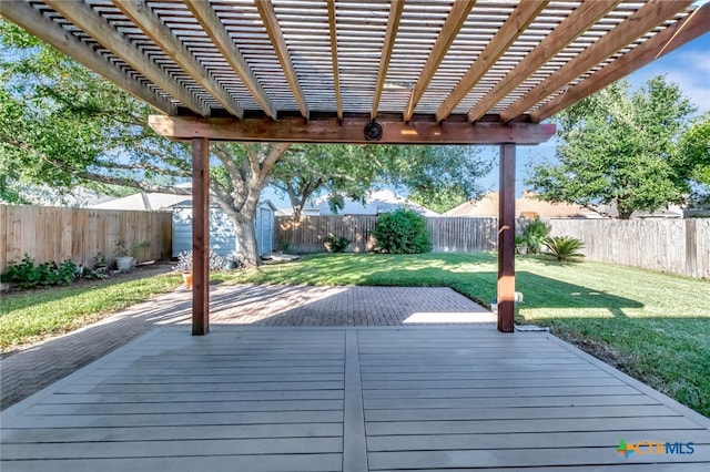 wooden terrace featuring a pergola and a lawn