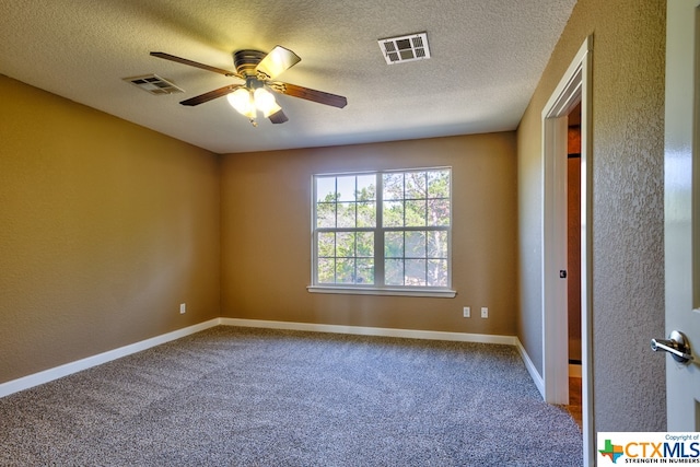 unfurnished room with a textured ceiling, carpet, and ceiling fan