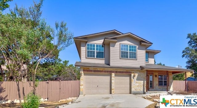 3037 Rustler, Canyon Lake, TX 78133 - view of front of house featuring stone siding, a garage, and concrete driveway
