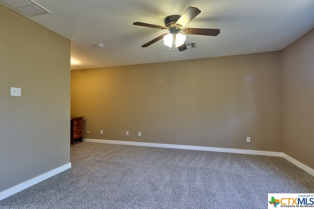 carpeted empty room with a textured ceiling and ceiling fan