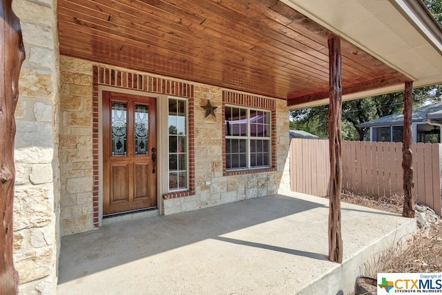 3037 Rustler, Canyon Lake, TX 78133 - property entrance with stone siding and a patio area