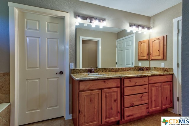 3037 Rustler, Canyon Lake, TX 78133 - bathroom featuring double vanity and a textured wall