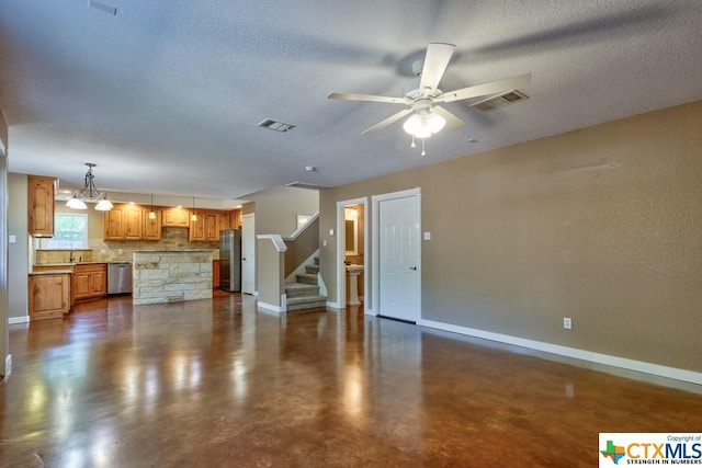 3037 Rustler, Canyon Lake, TX 78133 - unfurnished living room featuring finished concrete flooring, ceiling fan, a textured ceiling, stairway, and a chandelier