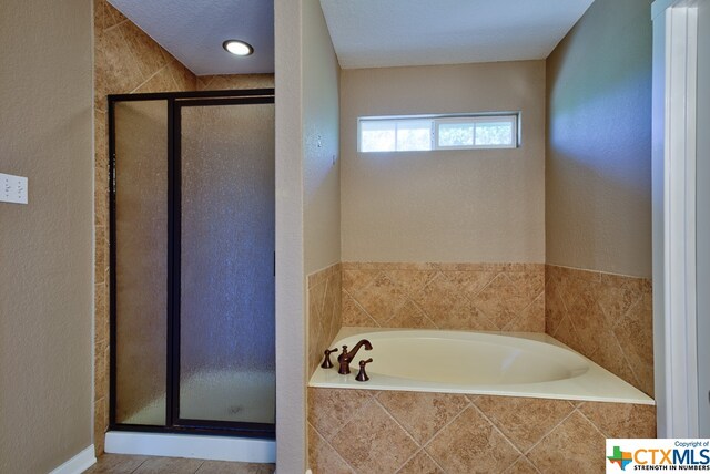 bathroom with independent shower and bath